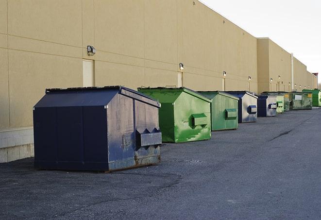 a pile of materials next to a construction dumpster in Bapchule